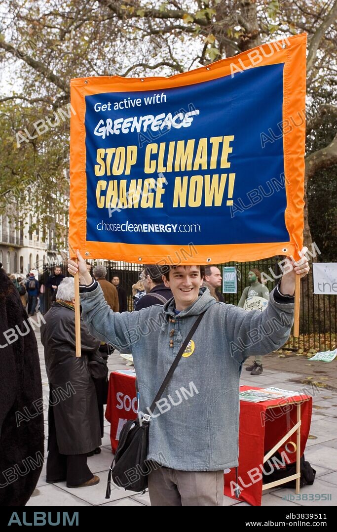 Greenpeace demonstrator with "Stop Climate Change Now" banner at a Climate Change March on December 3 in London, UK.
