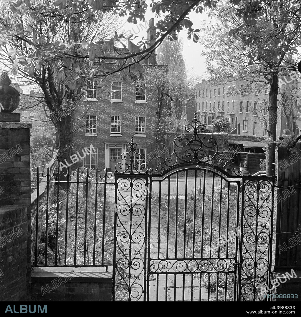 Gardnor House, Flask Walk, Hampstead, London, 1960-1965. Looking over the ornate garden gateway and railings towards the front elevation of Gardnor House.