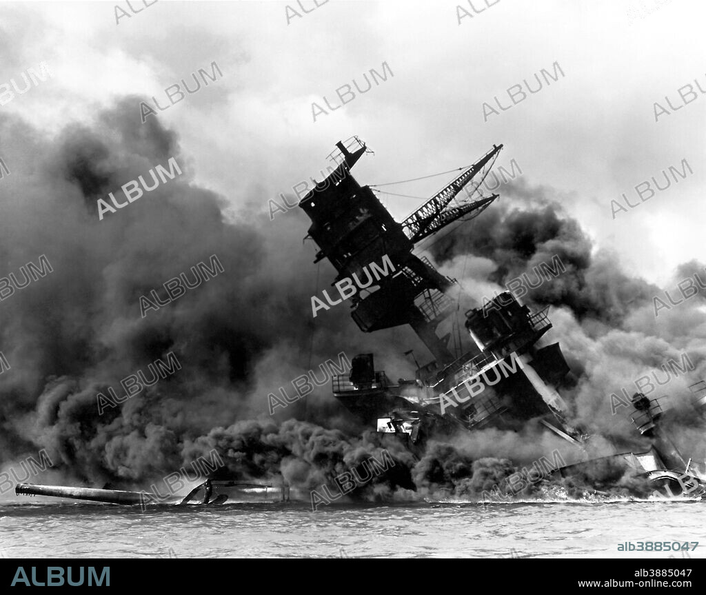 Vintage World War II photo of the USS Arizona burning after the Japanese attack on Pearl Harbor, December 7, 1941.