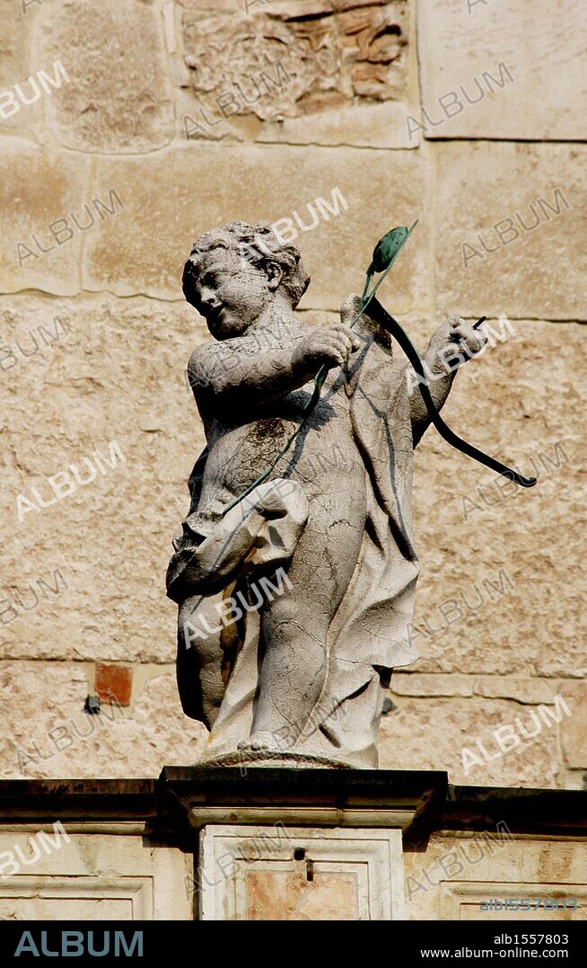 Cupid with bow and arrows. Sculpture. Facade of the Duomo in Cremona. Italy.