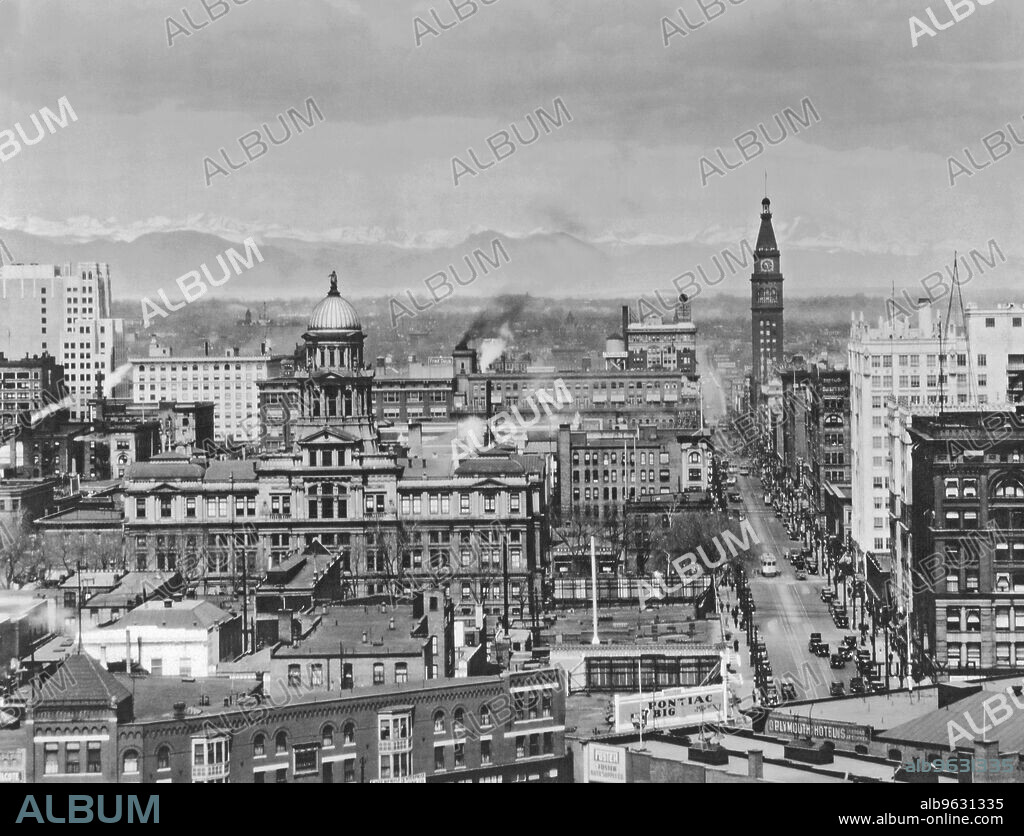Denver, Colorado, c 1930 View of cityscape with mountains in background.