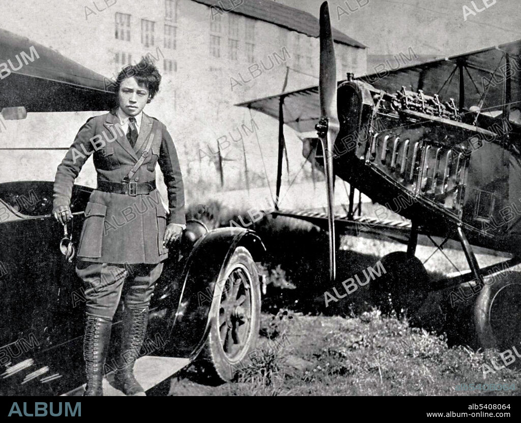 Bessie Coleman in tailor made officer's uniform posed standing on the running board of a Ford Model T automobile with nose and right wing of her Curtiss JN-4 Jenny to her left, 1922. Bessie Coleman (1892 - 1926) was an African-American civil aviator. She could not gain admission to American flight schools because she was black and a woman. She learned French, traveled to Paris, and in 1921, became the first woman of African-American descent to earn an international aviation license. No photographer credited, 1922.
