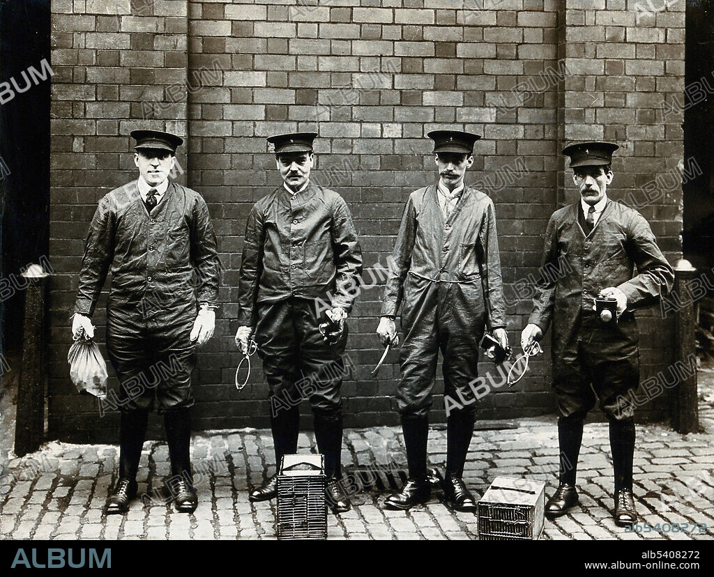 Liverpool Port Sanitary Authority rat-catchers dressed in protective clothing with traps and equipment, Liverpool, England. A rat-catcher is a person who practices rat-catching as a professional form of pest control. No photographer credited, 1900-1920s.