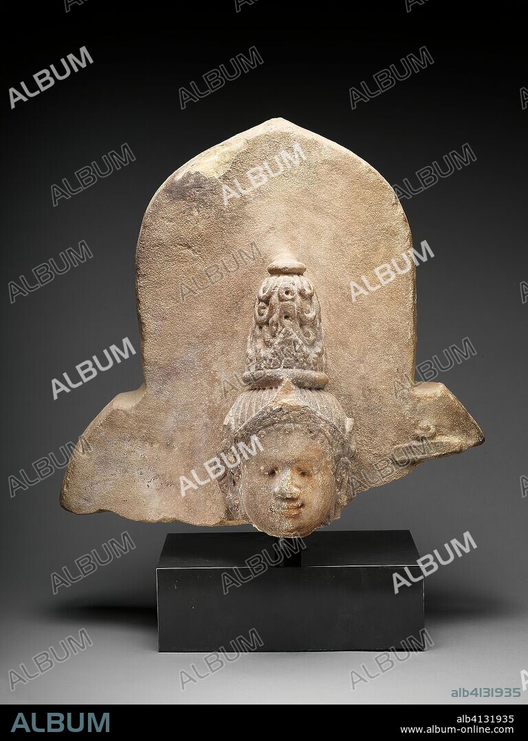 Head of a Female Deity. Indonesia; Borneo, Kutai Province, Gunung Kombeng. Date: 801 AD-1300. Dimensions: 37.2 × 39.7 × 21.6 cm (14 5/8 × 15 5/8 × 8 1/2 in.). Sandstone. Origin: Borneo.