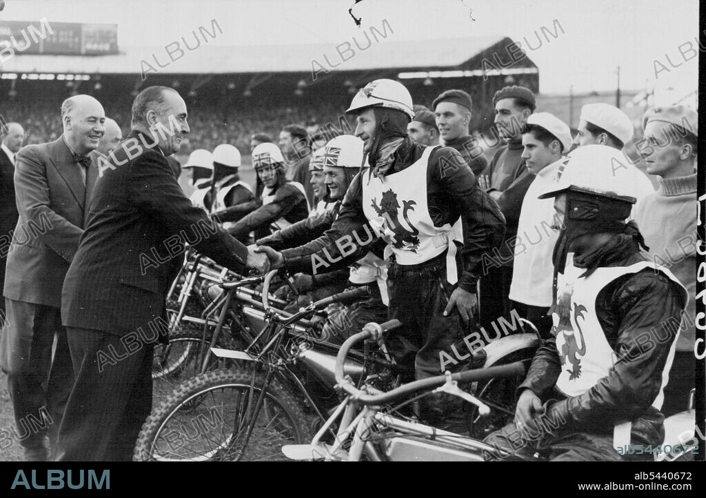 England Defeat Australia in Fourth Speedway Test Match: The Hon. Eric J. Harrison, Australian High Commissioner, shaking hands with Ron Clarke, when being introduced to the English team before the match. England defeated Australia by 62 points to 46 in the fourth Test Match at the Wimbledon Speedway, London. August 01, 1950. (Photo by Sport & General Press Agency, Limited).