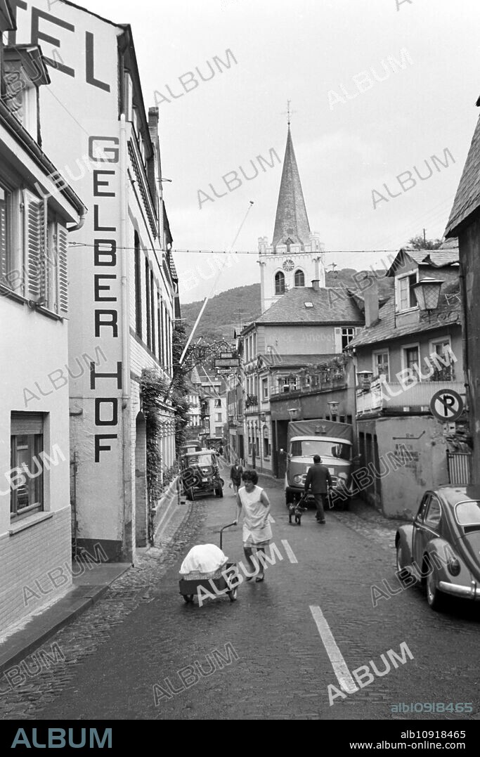 Hotel "Gelber Hof" and Protestant church Saint Peter on Bluecherstrasse street in Bacharach, Germany 1968.