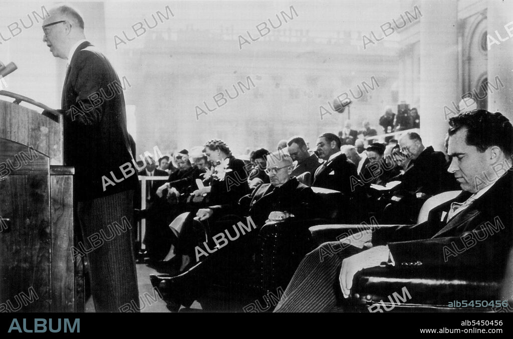 Presidential Prayer -- This was the scene Tuesday as President Dwight D. Eisenhower uttered the prayer with which he preceded his inaugural address in Washington. Behind the new President are former President Harry S. Truman and Vice President Richard M. Nixon. Beyond Mr. Truman are Mrs. Truman and Mrs. Eisenhower (nearest camera) and behind them are the President's son, Maj. John Eisenhower (light coat) and Forest Harness, Senate Sergeant-at-Arms. This picture was taken by a free-lance photographer who changed to get a seat in the Presidential stand where ***** authorized camera positions. It became available only today. February 06, 1953. (Photo by AP Wirephoto).