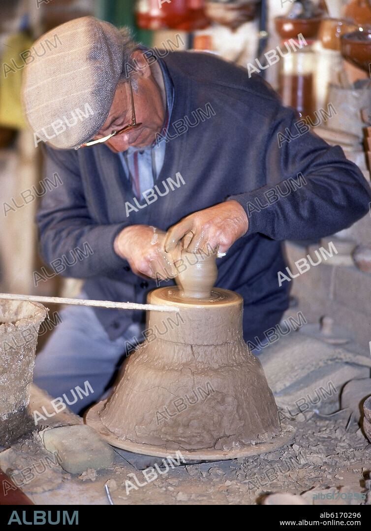 NICOLAS GUERRA GOMEZ (S XX) ALFARERO. ALFARERO TRABAJANDO UNA PIEZA EN EL TORNO.