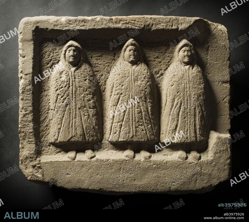 Three genii relief, Housesteads Fort, Hadrian's Wall, Northumberland, c2012. This relief of three 'genii cucullati' (hooded deities) was discovered in a domestic shrine in the civilian settlement outside the fort. Wrapped up against the cold northern winds, the 'hooded ones' wear thick woollen capes which were exported from Britain.