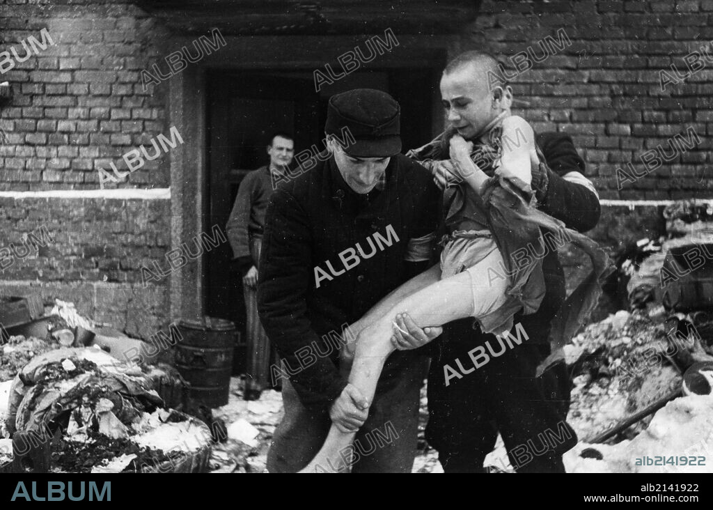 A 15 year old russian boy, ivan dudnik, who was brought to auschwitz from his home in the orel region by the nazis, being rescued, he has gone insane from witnessing the horrors of the camp, february 1945. 01/02/1945