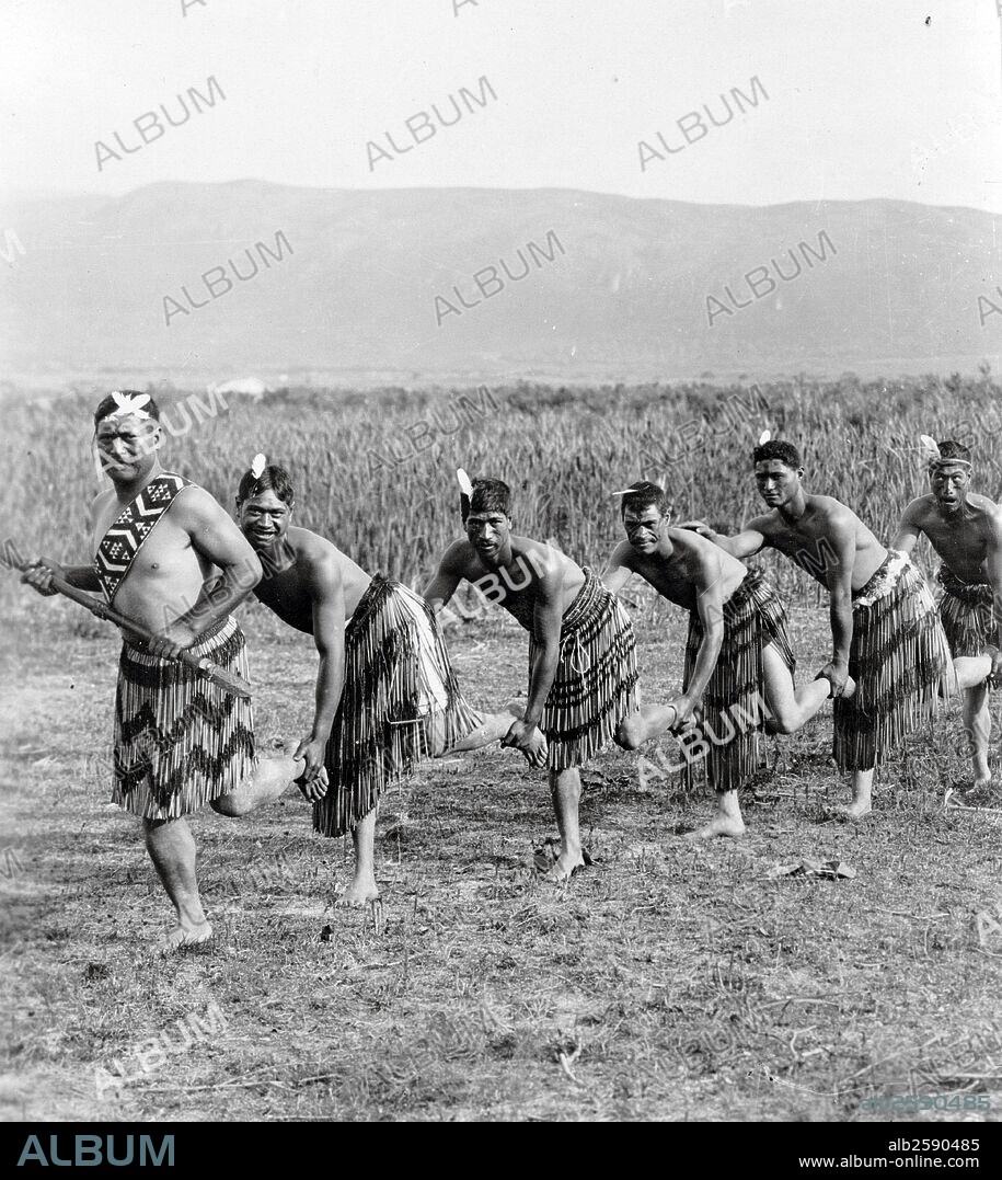 Photograph of five Maori men posing in traditional clothing performing the Haka dance. Haka is a traditional ancestral war cry, dance or challenge from the Maori people of New Zealand. Dated 1900 .