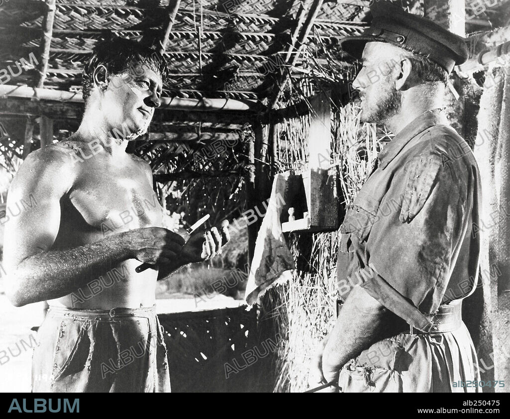 ALEC GUINNESS and WILLIAM HOLDEN in THE BRIDGE ON THE RIVER KWAI, 1957, directed by DAVID LEAN. Copyright COLUMBIA PICTURES.