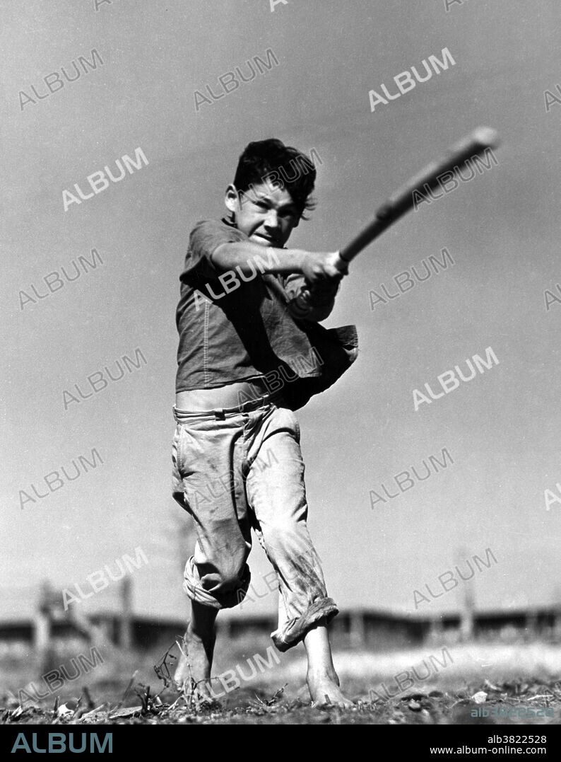 Entitled: "Farm Security Administration migratory farm labor camp. Saturday morning baseball game, Robstown, Texas" showing a boy swinging a baseball bat. Initially created as the Resettlement Administration (RA) in 1935 as part of the New Deal in the United States, the Farm Security Administration (FSA) was an effort during the Depression to combat American rural poverty Baseball is a bat-and-ball game played between two teams of nine players each who take turns batting and fielding. Evolving from older bat-and-ball games, an early form of baseball was being played in England by the middle of the 18th century. This game was brought by immigrants to North America, where the modern version developed. By the late 19th century, baseball was widely recognized as the national sport of the United States. Baseball is now popular in North America and parts of Central and South America and the Caribbean, East Asia, and Europe. Photographed by Arthur Rothstein, January 1942.