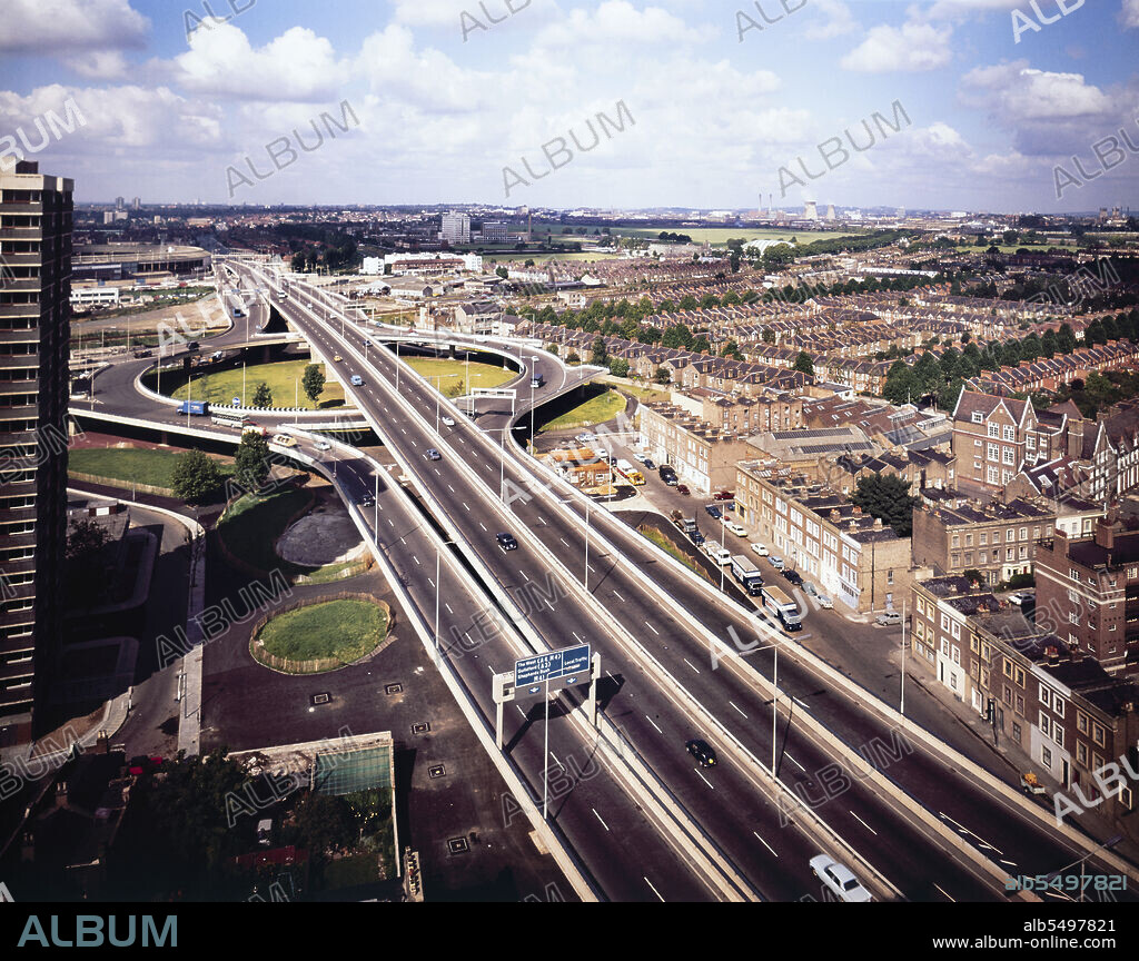 JOHN LAING PLC. Westway Flyover, A40, Kensington and Chelsea, London, 01/09/1971. An elevated view looking west at the junction between the Westway Flyover and the West Cross Route leading south. Work on site for the Western Avenue Extension began on 1st September 1966, and the Westway as it became known was officially opened on 28th July 1970. The elevated highway connecting the A40 at White City to Marylebone Road in Paddington, at around 2 ½ miles, was the longest in Europe. The construction was organised into six sections. Sections 1, 4, 5 & 6 formed the main flyover into central London with Sections 2 & 3 being the West Cross Route, running south from the junction in Section 1 near Latimer Road to Shepherds Bush. The West Cross Route was the first part of the London Motorway Box, part of the Ringway Project to encircle London with four concentric motorways. The Ringway Project was abandoned in 1975 with no further work on the West Cross Route. This photograph was taken at grid reference TQ2371381144.