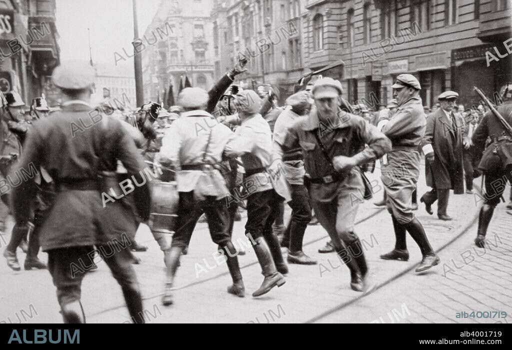 Men in Bolshevik uniform fighting police in the street, Germany, c1918-c1933(?) (1936). From Germany: The Olympic Year, published by Volk und Reich Verlag. (Berlin, 1936).