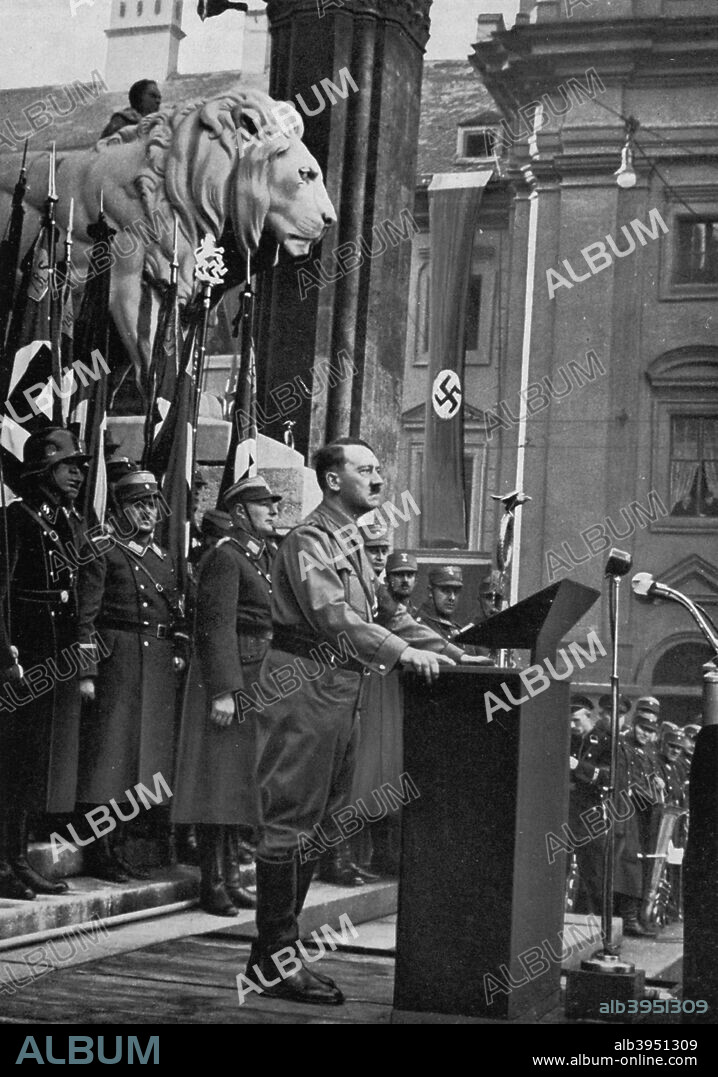 Adolf Hitler speaking at the Feldherrnhalle, Munich, Germany, 9 November 1934. Hitler (1889-1945) adressing newly-admitted members of the Hitler Youth and the League of German Girls. A print from Adolf Hitler. Bilder aus dem Leben des Führers, Hamburg: Cigaretten/Bilderdienst Hamburg/Bahrenfeld, 1936.
