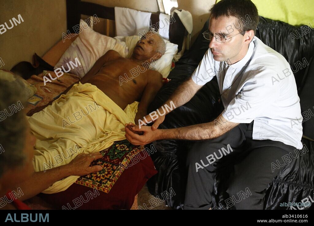 French priest Etienne Kern visiting a dying parishioner in Alagados favela.