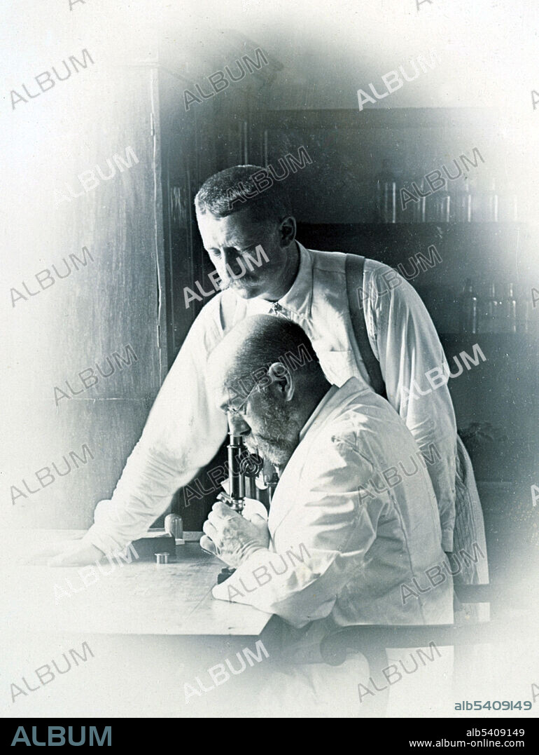 Professors Koch and Pfeiffer working in a laboratory, investigating the plague in Bombay.  Heinrich Hermann Robert Koch (December 11, 1843 - May 27, 1910) was a German physician and microbiologist. As the founder of modern bacteriology, he identified the specific causative agents of tuberculosis, cholera, and anthrax and gave experimental support for the concept of infectious disease, which included experiments on humans and animals. Koch created and improved laboratory technologies and techniques in the field of microbiology, and made key discoveries in public health. His research led to the creation of Koch's postulates, a series of four generalized principles linking specific microorganisms to specific diseases that remain today the gold standard in medical microbiology. For his research on tuberculosis, Koch received the Nobel Prize in Physiology or Medicine in 1905. In 1910, Koch suffered a heart attack and never made a complete recovery. Three days after giving a lecture on his tuberculosis research at the Prussian Academy of Sciences, Koch died in Baden-Baden at the age of 66. Following his death, the Institute named its establishment after him in his honor. Richard Friedrich Johannes Pfeiffer (March 27, 1858 - September 15, 1945) was a German physician and bacteriologist. Photograph attributed to Captain C. Moss, 1897.