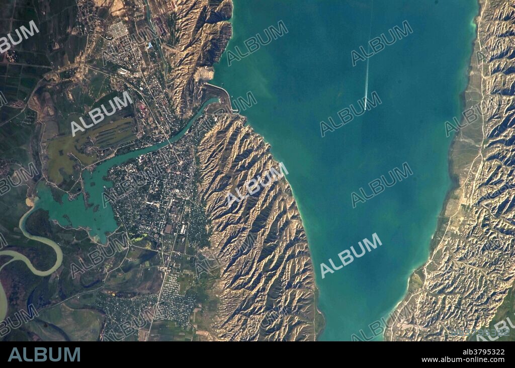 View from space of the Mingachevir Reservoir in north-central Azerbaijan. Also visible is the nearby city of Minachevir (left), split by the Kur River as it passes through the dam and hydroelectric power station complex at image top center.