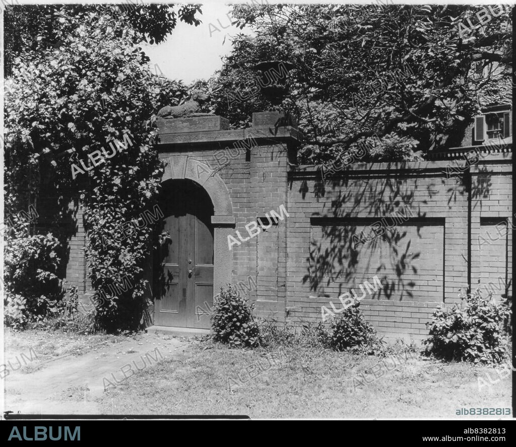 FRANCES BENJAMIN JOHNSTON. Corcoran House, at NE corner of Conn. and H, N.W., Washington, D.C., c1900. Brick garden wall and portal topped by sculpture of dog. Home of William Wilson Corcoran.