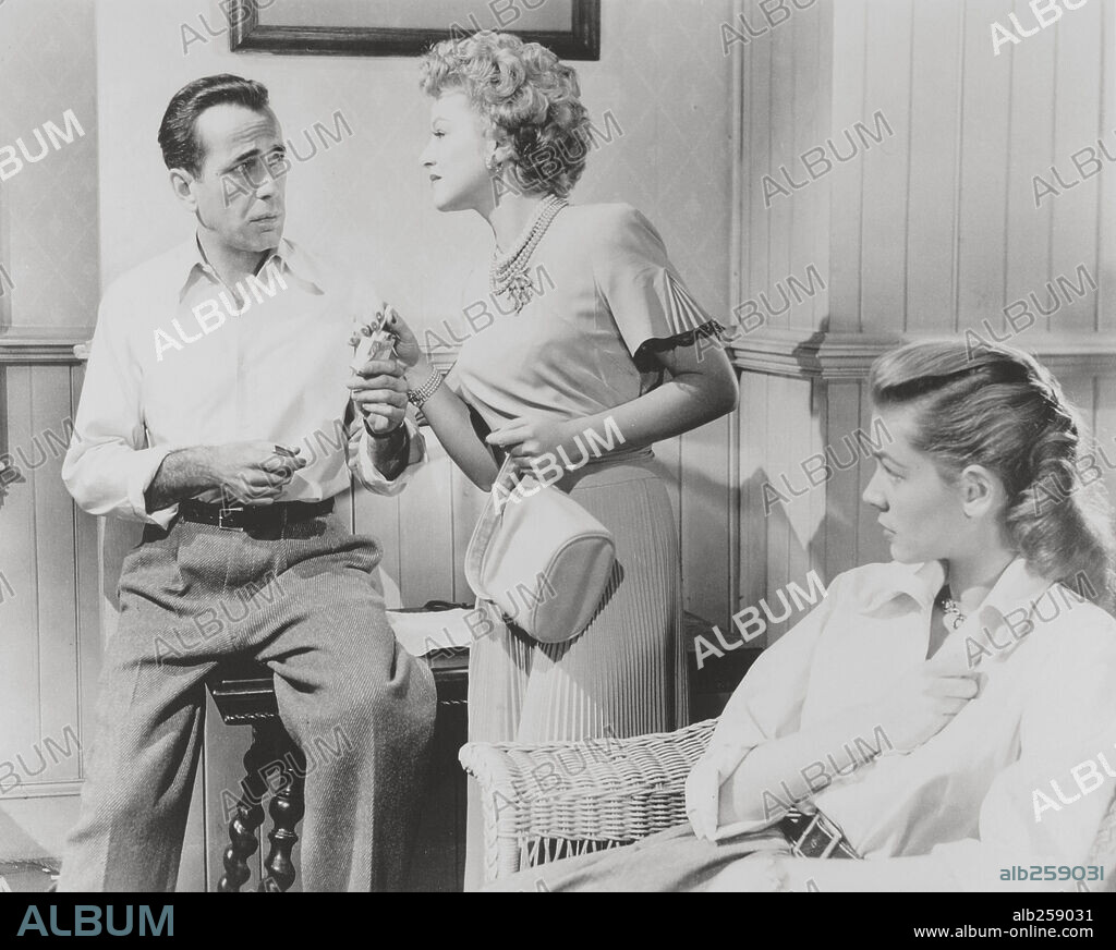 CLAIRE TREVOR, HUMPHREY BOGART and LAUREN BACALL in KEY LARGO, 1948, directed by JOHN HUSTON. Copyright WARNER BROTHERS.