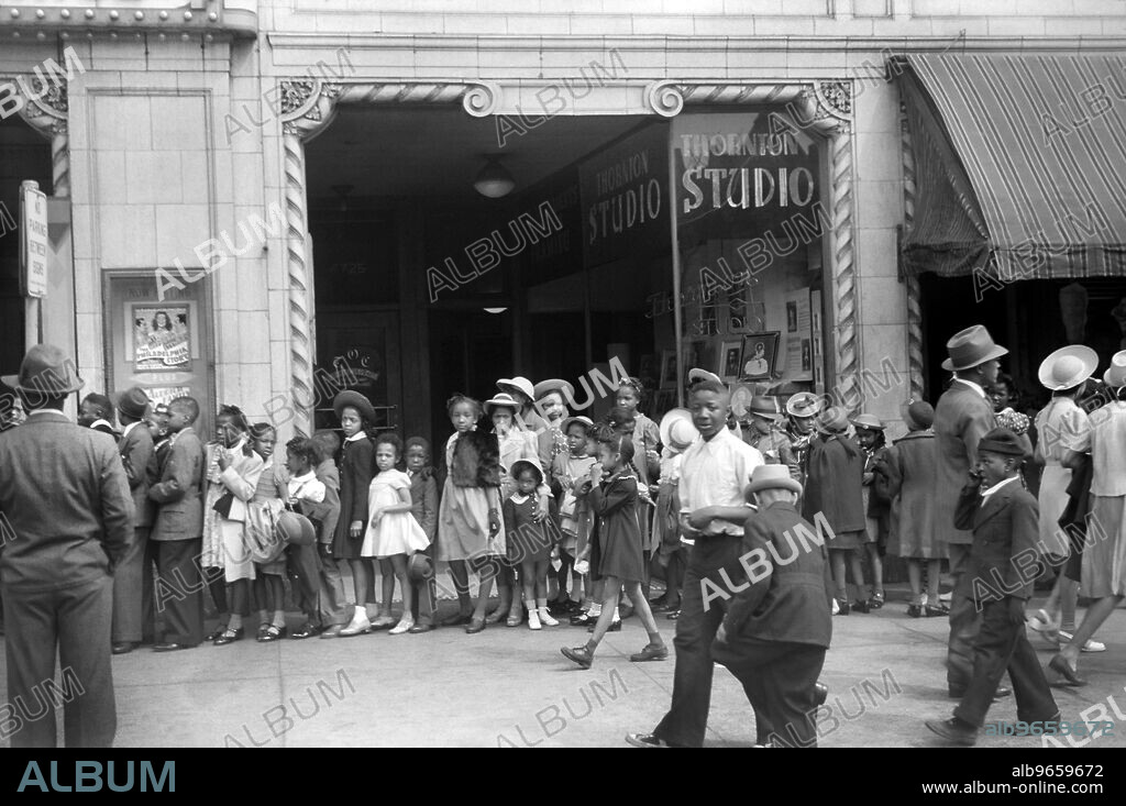 Children in front of Moving Picture Theater, Easter Sunday Matinee, Black Belt, Chicago, Illinois, USA, Edwin Rosskam for U.S. Farm Security Administration, April 1941.