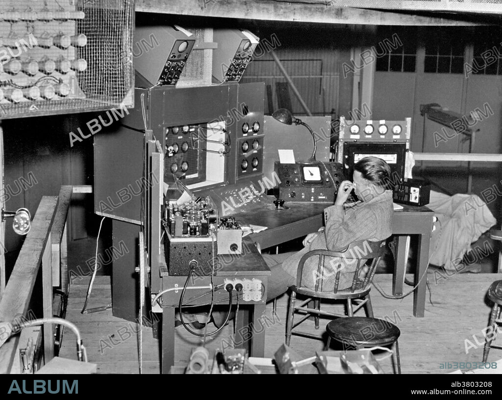 Lawrence slumps from fatigue in his chair at the control panel of the cyclotron during calutron test. In August the first racetrack began to operate, successfully it was thought; but it soon collapsed, its vacuum leaky and its tanks warped by its mighty magnet. Lawrence and others flew in from Berkeley to diagnose the ailing racetrack, which was dismantled and returned to its manufacturers. The pressure overwhelmed even Lawrence. He spent the end of 1943 in a hospital in Chicago. Ernest Orlando Lawrence (August 8, 1901 - August 27, 1958) was an American physicist and Nobel Laureate, known for his invention, utilization, and improvement of the cyclotron atom-smasher beginning in 1929, based on his studies of the works of Rolf Wideroe, and his later work in uranium-isotope separation for the Manhattan Project. In 1939, Lawrence was awarded the Nobel Prize in Physics for his work in inventing the cyclotron and developing its applications. After the war, Lawrence campaigned extensively for government sponsorship of large scientific programs. Lawrence was a forceful advocate of "Big Science" with its requirements for big machines and big money. He'd died in 1958 at the age of 57.