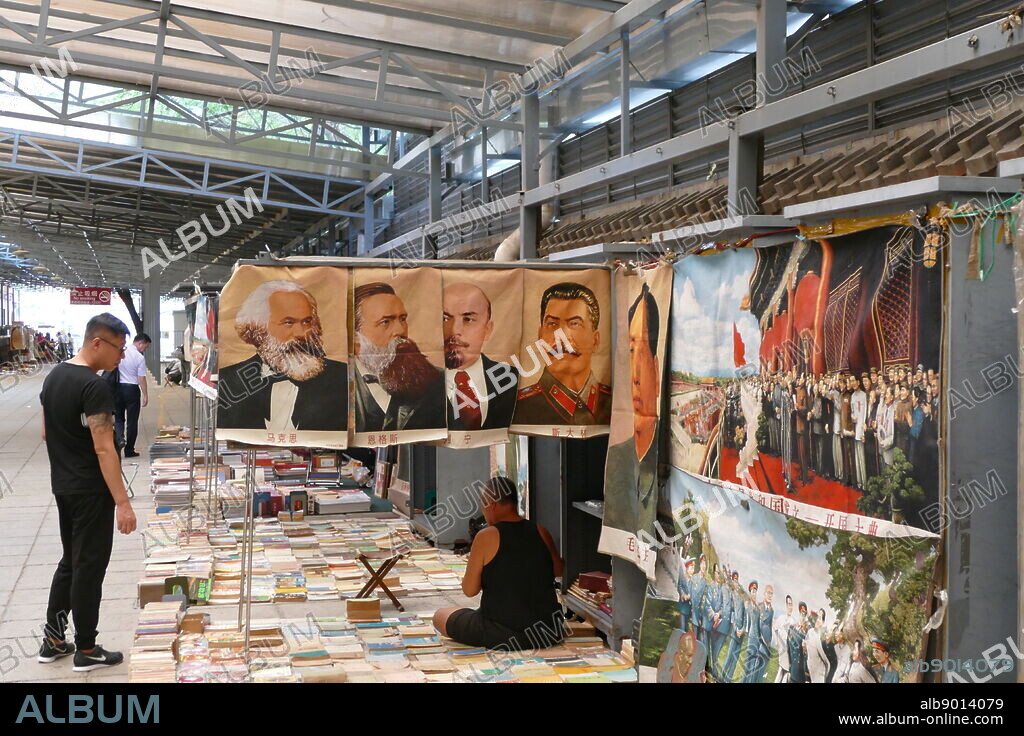 Portraits of Karl Marx, Friederich Engels, Vladimir Lenin and Joseph Stalin in a Chinese market. These popular symbols of communism sit alongside a portrait of Chairman Mao.