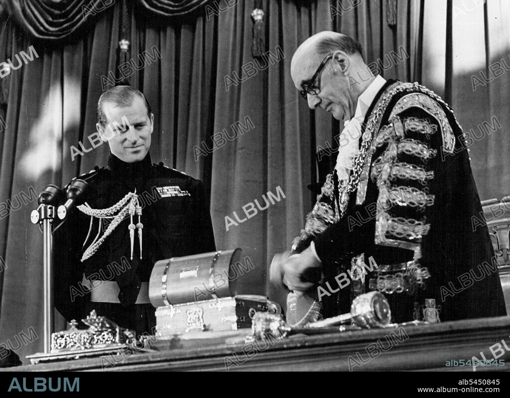 The Duke of Edinburgh Admitted Honorary Freeman Of Cardiff -- The Lord Mayor of Cardiff, Alderman G. Llewellyn Ferrier presents the casket, seen on table to the Duke.Nearly 1,100 people gathered in the assembly rooms at the city hall when the Duke of Edinburgh was admitted as an Honorary freeman of Cardiff. The scroll of admission was handed to him in a casket made of teak in the shape of a sea chest, with rope handles and bound in gilded Brass. on one side were the Duke's Personal arms in enamel and silver, and on the other the arms of the City of Cardiff. The wood came form H.M.S. Ajax which tool part in the river plate action during the war and was broken up in South Wales Shipyard five years ago. December 02, 1954. (Photo by Paul Popper, Paul Popper Ltd.).