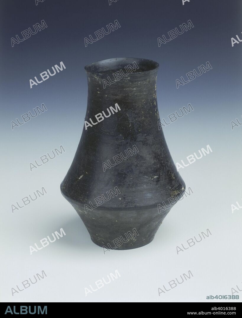 Black pottery beaker, Longshan culture, China, c2500 BC. An undecorated black beaker of very thin construction. The interior shows signs of having been formed on a potter's wheel, waisted outwards two thirds of the way down from rim to base. The beaker has a solid base.