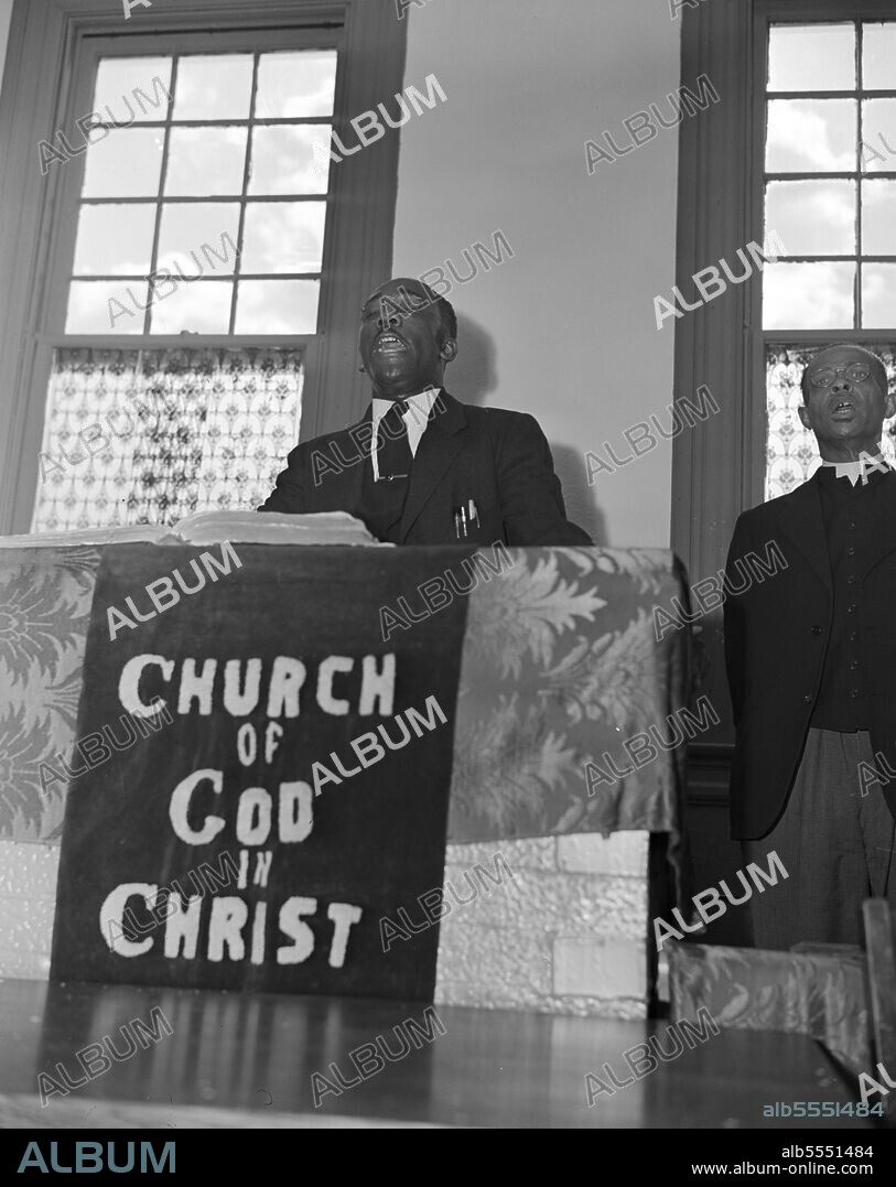 GORDON PARKS. Washington, D.C. Elder Kelsey, pastor of the Church of God in Christ, opening a service with a song.