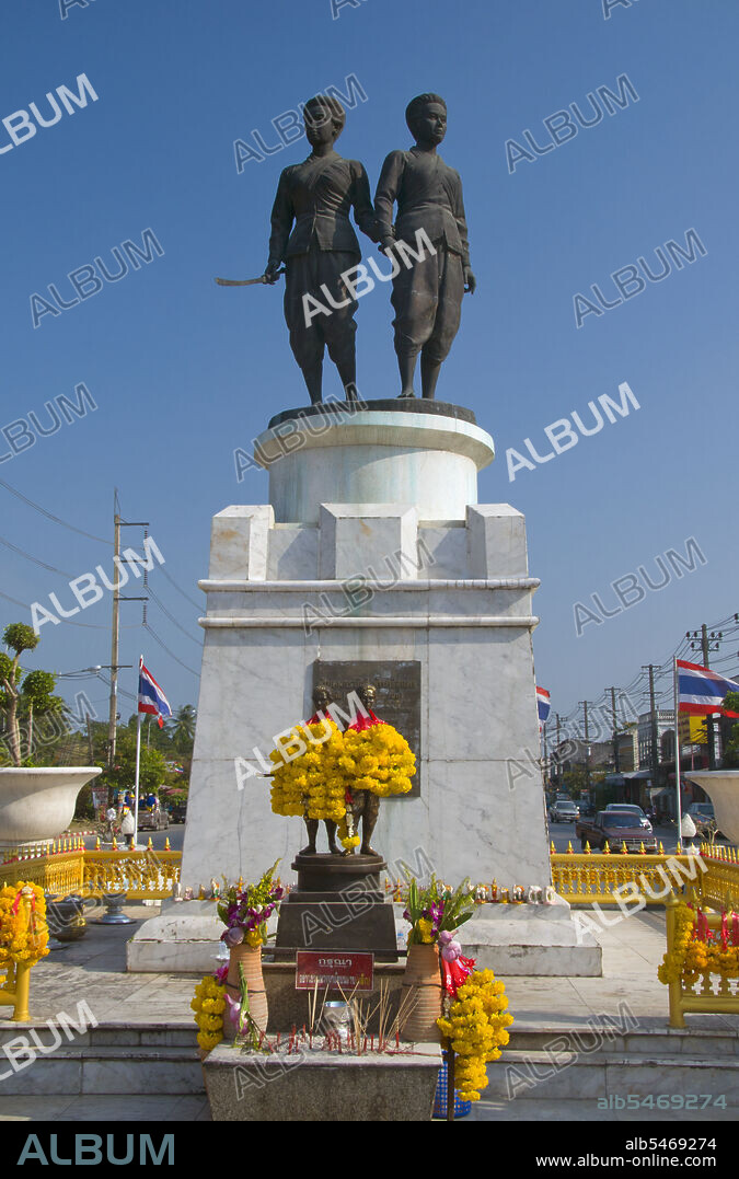 Rama I's Chakri dynasty met its first great test in the massive Burmese invasion of 1785. King Bodawpaya of Burma (1781-1819) sent more than 100,000 troops in five armies against Siam. The Burmese forces that invaded southern Thailand enjoyed initial success but were halted at Thalang, in central Phuket, by the bravery of the local defenders. Two sisters - Chan, or 'Date Plum', and Muk, or 'Pearl', the widow and sister-in-law of the late governor, organised the resistance by ordering the local women to cut their hair short and dress as men. When the Burmese commander saw the defences, he was fooled into thinking Thalang had many more soldiers than was actually the case! The court in Bangkok, on learning of the two sister's brave action, distinguished them with royal titles. Miss Chan was named Thepkasatri, or 'Angelic Queen', and Miss Muk became Si Sunthorn, or 'Goddess of Beauty'. Today they are still seen as local folk heroes and spiritual guardians of the island. They stand together on the Heroine's Monument at Thepkasatri Road, brandishing long swords towards any future invaders of the island.