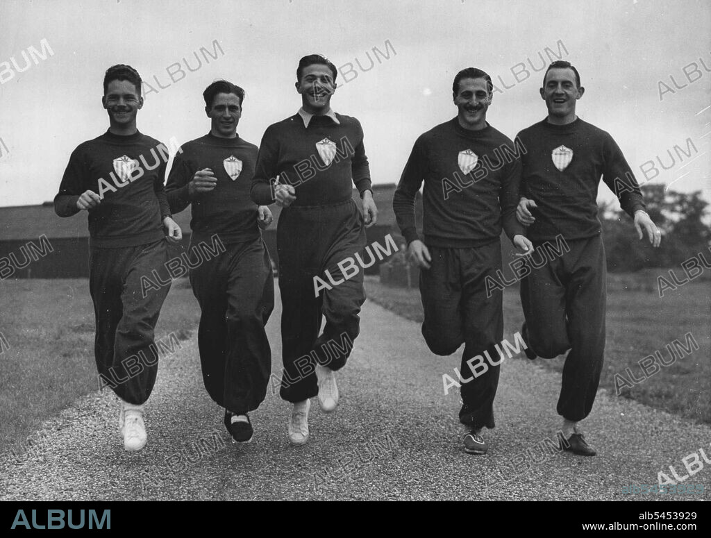 Uruguayan Athletes Settle In : Runners and Jumpers limber up at Old Deer Park, Richmond - where they arriving yesterday. Left to Right, they are Walter Peres (100 & 200 metres). Mario Fayos (100 & 200 metres); Juan J. Lopez Testa (100 & 200 metres); Hercules Ascune Posta (400 metres and high jump); and Pedro Listur (High jump). Testa (centre), at a meeting in Buenos Aires last year, ran the 100 metres in 10.2 seconds, beating several athletes of international fame.The Uruguayan Olympic Games athletics team has begun arriving in London - the first of five batches is now settling in in their quarters in Old Deer Park, Richmond. July 15, 1948. (Photo by Fox).