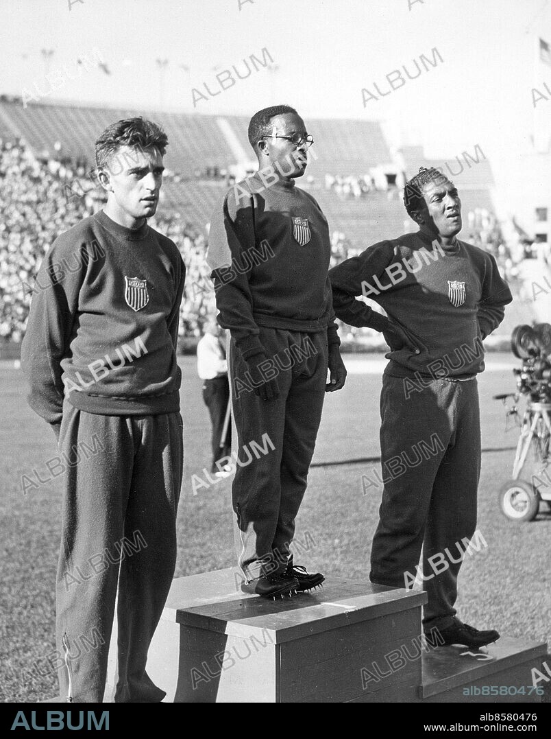 USA LOS ANGELES 1932-08-05.. De tre medaljörerna på prispallen efter 200 meters-finalen vid de olympiska sommarspelen 1932. I mitten ses segraren Eddie Tolan, USA, som vann på olympiska rekordtiden 21,2 sek. före tvåan George Simpson (tv), USA, och trean Ralph Metcalfe (th), USA.. Foto: Wide World Photos / AB Text & Bilder / SVT / Kod: 5600. Engelsk originalbildtext.. Mapp: Los Angeles-olympiaden 1932 Löpning: 200, 400 m. (herrar) I.257.f. Trio Prisutdelningar.