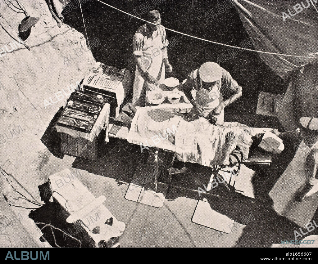 Field surgery on Gallipoli Peninsula Turkey 1915 Surgeon is removing bullet from arm of soldier From The War Illustrated Album deLuxe published London 1916.