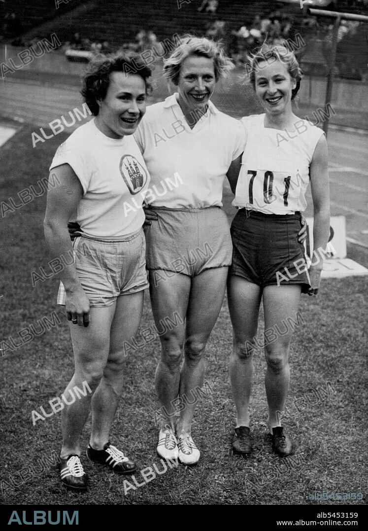 Anniversary Meet At Olympic Stadium -- Fanny Blankers-Koen of Holland, who was expected to retire after her mishaps in the Olympics and immediately afterwards, was in very good shape in Berlin.She won the 100-metre event in 11.7 seconds; and the 80-metre Hurdles in 11.1 seconds. She also won the long jump event with a leap of 5.89 metres here with her here are Shirley Strickland of Australia (right) and Maria Sander Germany (left), after the events. September 23, 1952. (Photo by Associated Press Photo).