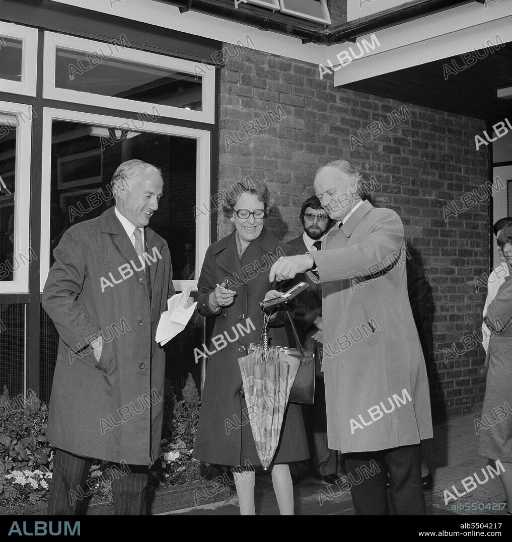 JOHN LAING PLC. Farriers Hall Community Centre, Farriers Way, Borehamwood, Elstree and Borehamwood, Hertsmere, Hertfordshire, 20/10/1978. F Bryer, Director of Laing's Building Division, presenting Councillor J Tatham with the key to the old people's club on the Furzehill Road housing development. Laing began work on the Furzehill road contract in March 1976. 395 houses and flats would accommodate around 1,400 people. The site was a former 'Home of Rest for Horses,' giving rise to street names like Farriers Way. The contract became an unofficial training ground for apprentices and the old people's club was built entirely by apprentices.  J Tatham represented the Greater London Council's Housing Management Committee.