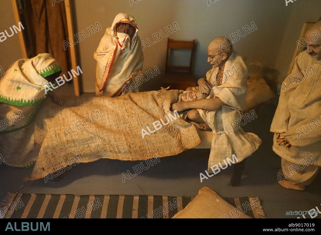Photograph of a model reconstructing Mahatma Gandhi watching his wife Kasturba Gandhi dying in 1944. Dated 21st Century.