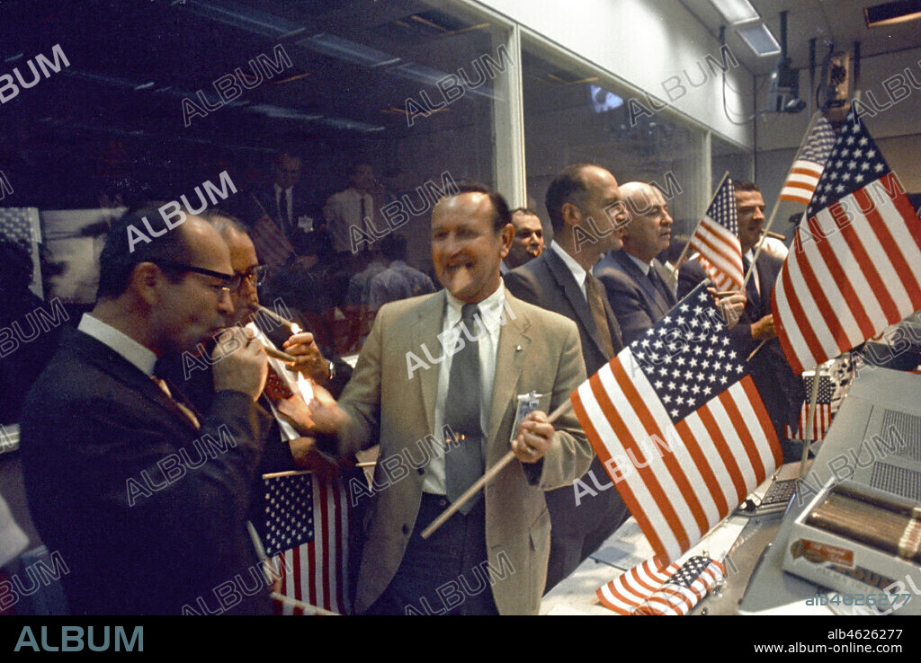 Apollo 11 - NASA, 1969. NASA and Manned Spacecraft Center (MSC) officials joined with flight controllers to celebrate the successful conclusion of the Apollo 11 lunar landing mission in the Mission Control Center. From left foreground Dr. Maxime A. Faget, MSC Director of Engineering and Development; George S. Trimble, MSC Deputy Director; Dr. Christopher C. Kraft Jr., MSC Director fo Flight Operations; Julian Scheer (in back), Assistant Adminstrator, Office of Public Affairs, NASA HQ.; George M. Low, Manager, Apollo Spacecraft Program, MSC; Dr. Robert R. Gilruth, MSC Director; and Charles W. Mathews, Deputy Associate Administrator, Office of Manned Space Flight.