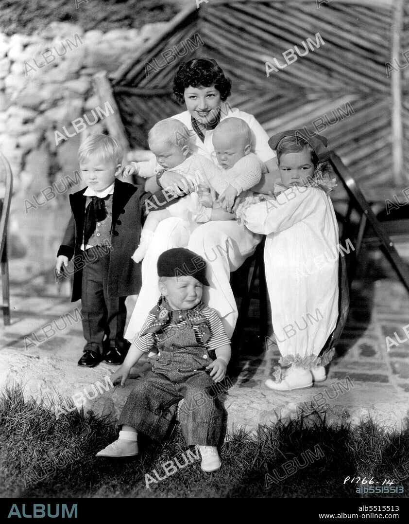 Miss Judge holding the Bing Crosby twins, Dennis Michael and Phillip Lang, while standing at the left is their older brother, Gary Evan, and at the right, Charles Wesley. Hollywood Starlets Celebrate - When its birthday time in Hollywood, there are balloon and lollypop trees, merry-go- rounds and ponies. Children of the stars recently gathered in costume at the home of Arline Judge and Wesley Ruggles, Paramount director, to celebrate the second birthday of the couples son Charles Wesley Ruggles. January 01, 1935.