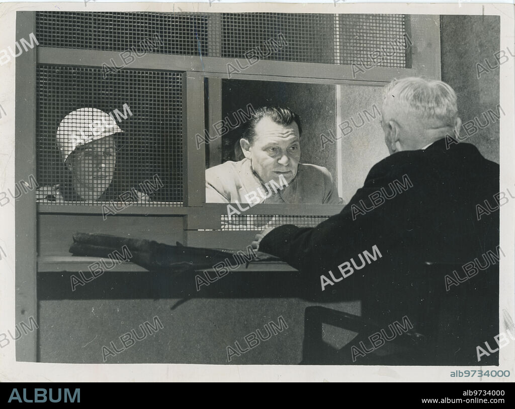 Nuremberg (Germany), March 1946. Nuremberg Trial. In the image, like every afternoon, Herman Goering's lawyer, Dr. Otto Stehmer, discusses the previous session with his client and prepares for the next one. Goering and his defender read the prosecutor's questions and study the answers.