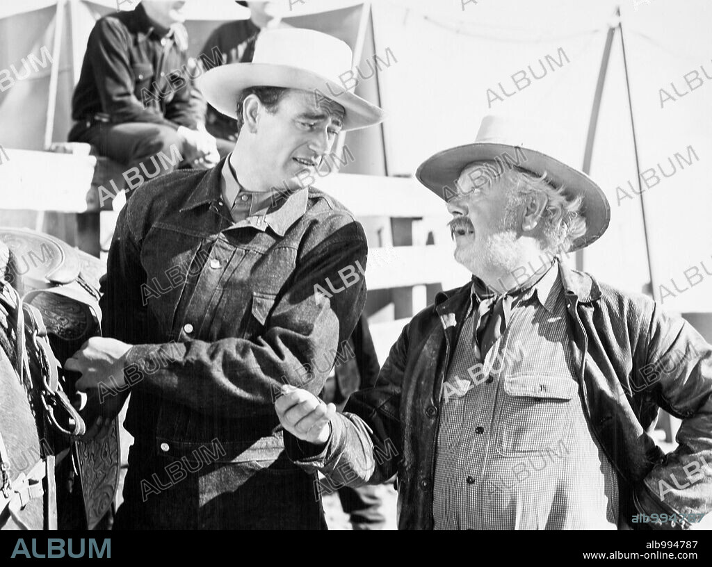 CHARLES WINNINGER and JOHN WAYNE in A LADY TAKES A CHANCE, 1943, directed by WILLIAM A. SEITER. Copyright RKO.