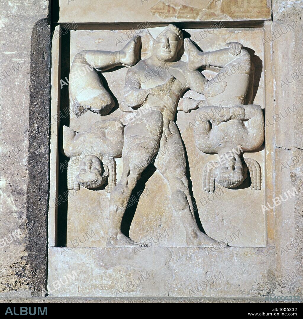 Metope of Herakles and the Kerkopes, from temple C at Selinunte on Sicily. Herakles is carrying them around on his shoulders because they have stolen his weapons, and they are laughing at his hairy bottom, 6th century BC.