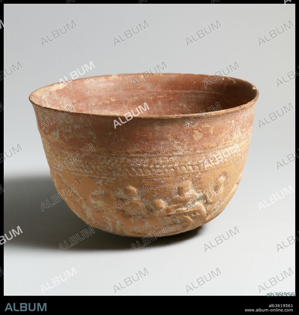 Terracotta Megarian bowl. Culture: Greek, Boeotian. Dimensions: h. 3 1/4 in. (8.3 cm); w. 5 1/2 in. (14 cm). Date: 2nd century B.C..
This vase belongs to a select group of bowls decorated in relief with scenes from epic poetry and from Classical Greek tragedy. Depicted here are five scenes from Euripides's play Iphigenia at Aulis, including inscriptions that identify the figures. Represented are: Agamemnon, who has weakened in his resolve to sacrifice his daughter to Artemis, biding his slave to take a letter to his wife, Clytemnestra, instructing her not to send her daughter to Aulis; Menelaos, Agamemnon's brother, taking the letter from the messenger by force; Menelaos, with the letter in hand, blaming Agamemnon for refusing to go through with the sacrifice; a messenger, bringing news to Agamemnon that Iphigenia has arrived; and the cart that has come from Argos, bearing Queen Clytemnestra and her children, Iphigenia and the little Orestes. The story continued on a second bowl, examples of which are preserved, again with five episodes, concluding with Iphigenia's meeting with Achilles. It is likely that a third bowl brought the story to its conclusion with Iphigenia's sacrifice.