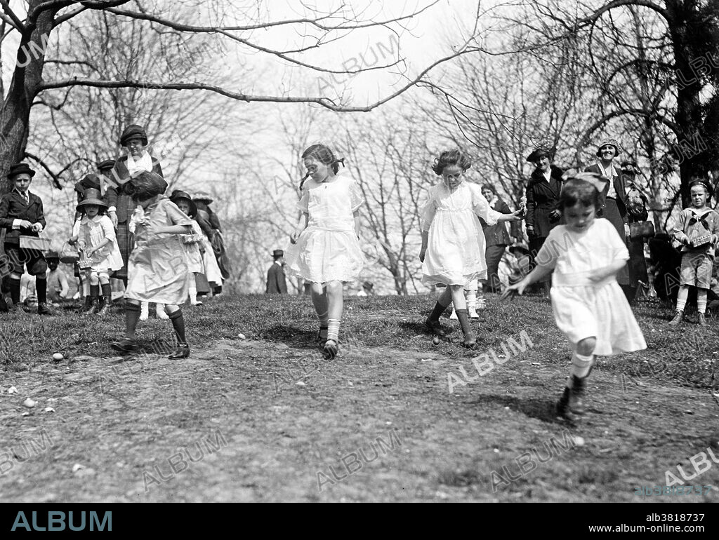 In the United States, the Easter Egg Roll is an annual event, and is held on the White House lawn each Easter Monday for children and their parents. The Egg Roll itself is a race, where children push an egg through the grass with a long-handled spoon. Surrounding events include appearances by White House personalities in Easter Bunny costumes, speeches and book-reading by Cabinet secretaries, and exhibits of artistically-decorated eggs. Many Americans follow the tradition of coloring hard-boiled eggs and giving baskets of candy. The Easter Bunny is a popular legendary anthropomorphic Easter gift-giving character analogous to Santa Claus in American culture. Photographed by the National Photo Company, March 28, 1922.