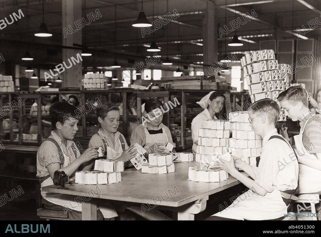 Boys folding boxes for Rowntrees Nux Chocolates in the packing department, Rowntree factory, York. Yorkshire, 1940.