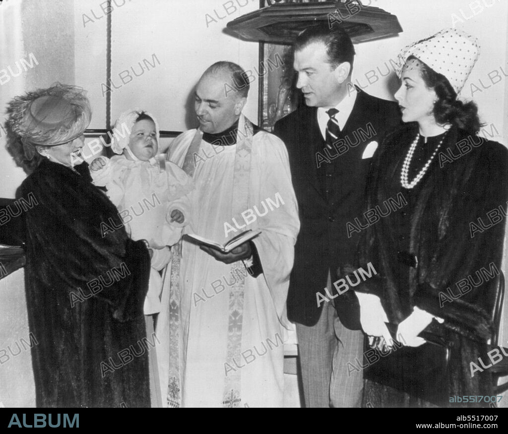 Hedy's Daughter Christened -- With Mama Hedy Lamarr and Papa John Loder watching eagerly, 10-months-old Denise Hedwig Loder awaits her christening at all Saints Eposcopal Church today. Godmother Bette Davis is holding her here, but later, unimpressed by Miss Davis cooing and clucking, she went to the arms of her father. Rev. J. Herbert Smith officials. April 08, 1946. (Photo by AP Wirephoto).