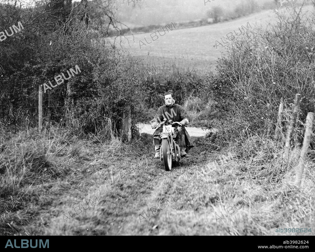 Syke riding an Ariel 4 during the Inter Varsity motor cross hill climb, November 1931. The company was founded by James Starley and William Hillman in 1870 to make bicycles and the first patented tensioned wire-spoke wheel. Ariel first made a powered tricycle in 1898 using a de Dion engine. They made their first motorized two-wheeler in 1901, powered by Kerry engines, selling them in 1902. The company closed in 1970.