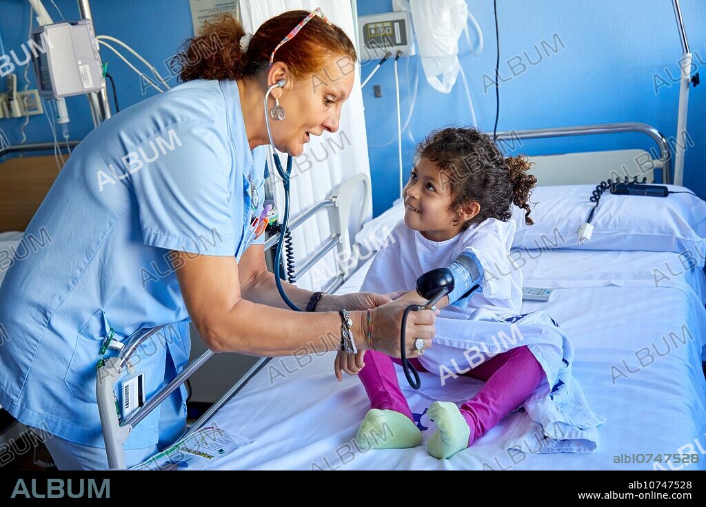 Nurse taking blood pressure to girl, Plant for hospitalization of children, Pediatrics, Medical care, Hospital Donostia, San Sebastian, Gipuzkoa, Basque Country, Spain.
