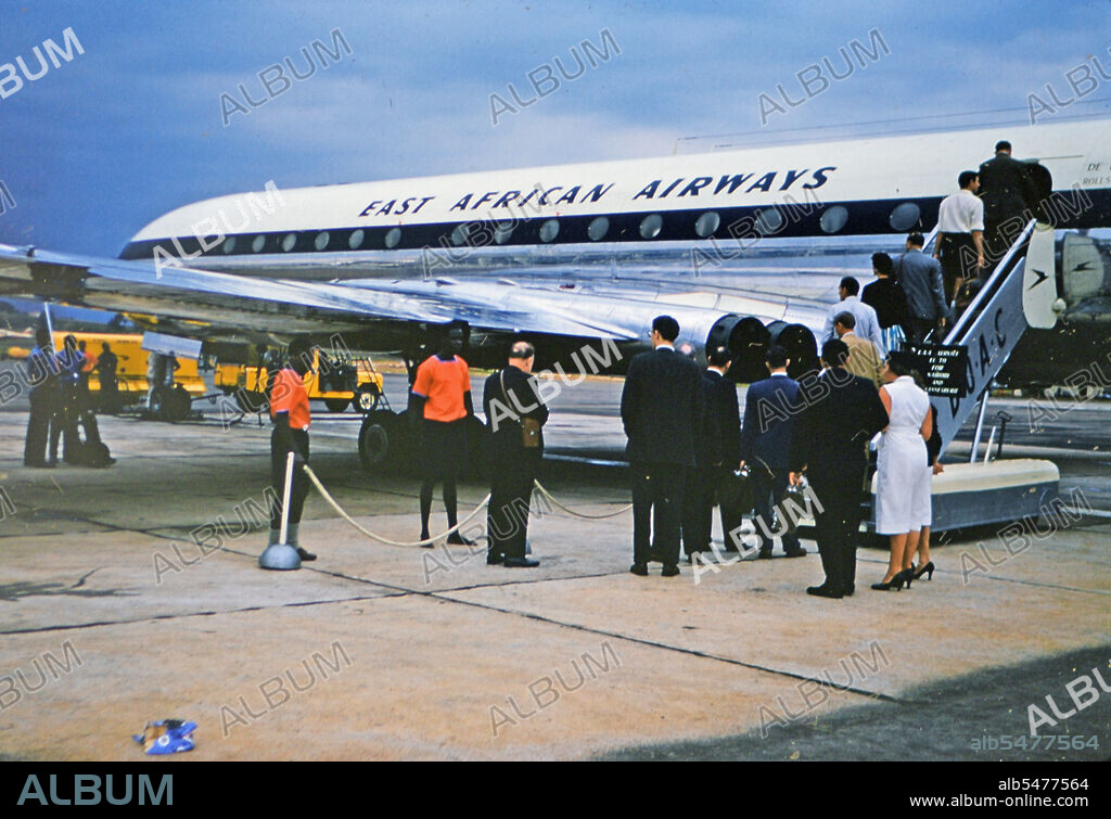 1961 Africa - Passnegers on a tarmac boarding an East African Airways airplane .
